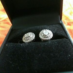 A pair of diamond earrings on sterling silver